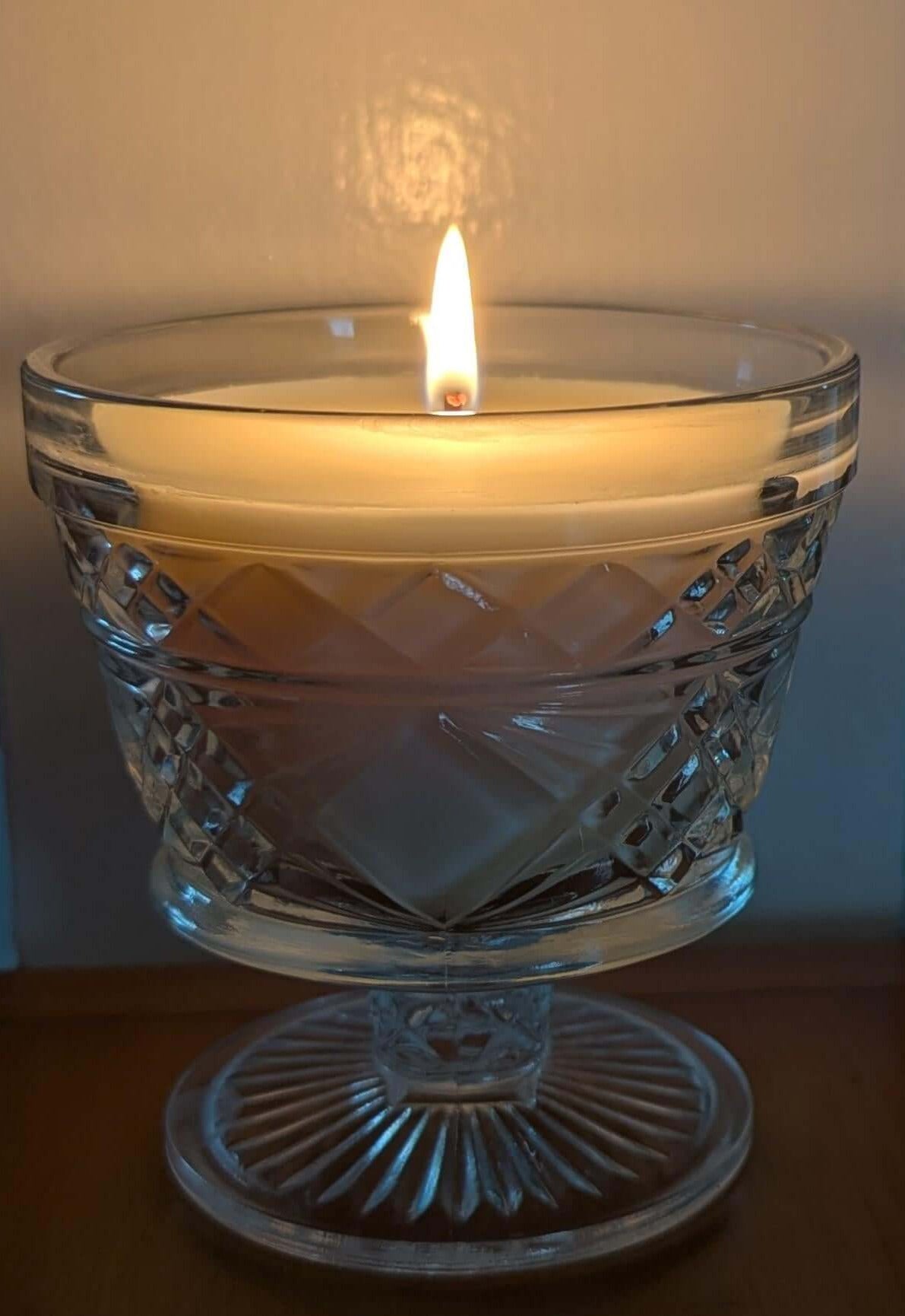 Hand-poured unscented coco-soy wax candle in glass holder, creating a warm ambiance for dining, yoga, or spa moments.