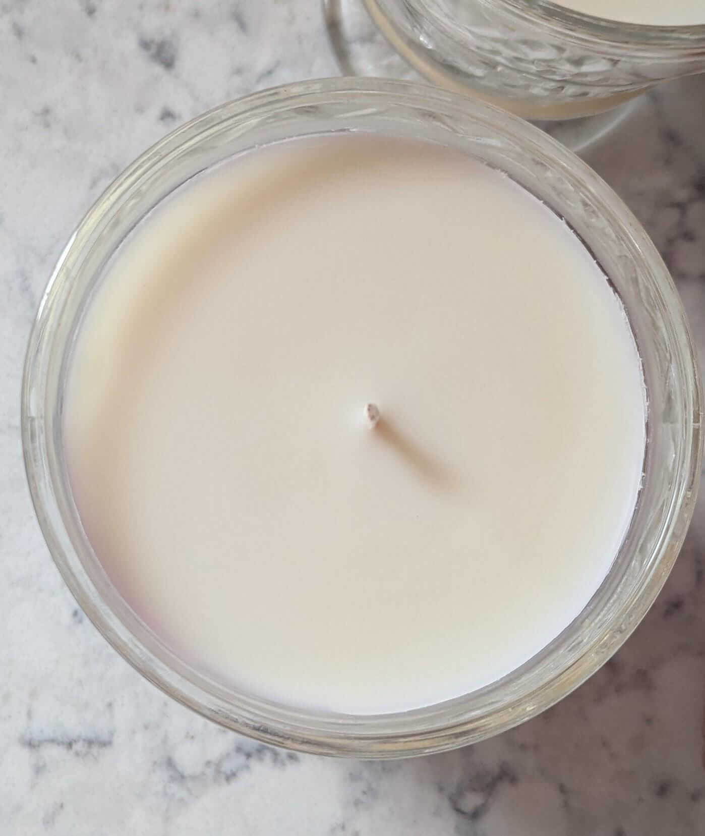 Top view of a hand-poured 6 oz unscented coco-soy wax candle in clear glass container.